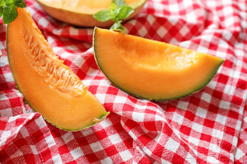 Pieces of tasty ripe melon on table