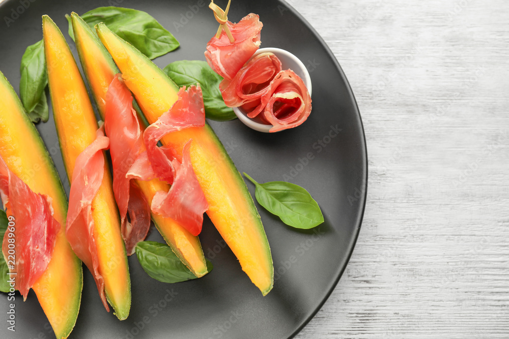 Delicious melon with prosciutto on plate