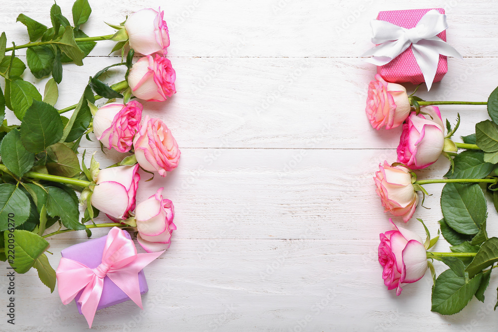 Beautiful roses on white wooden table