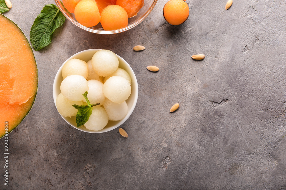 Bowls with delicious melon balls on table