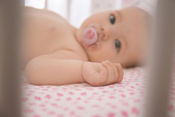 Wall Mural - Cute little baby lying in crib