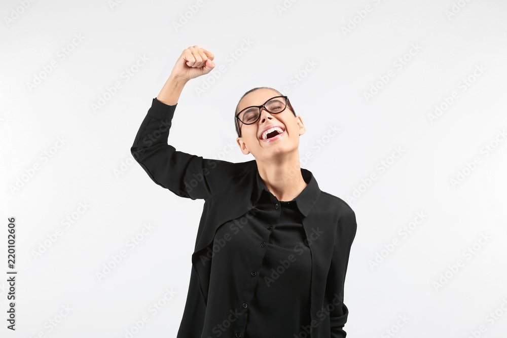 Happy successful young woman on light background