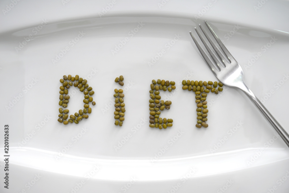 Word "Diet" made with green gram on white plate, closeup. Healthy food concept
