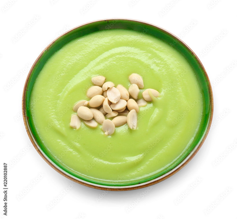 Bowl with tasty zucchini soup on white background