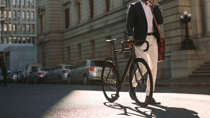 Man going to work with cycle using phone