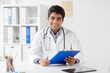 © Syda Productions - medicine, healthcare and people concept - happy male doctor with stethoscope and clipboard at clinic