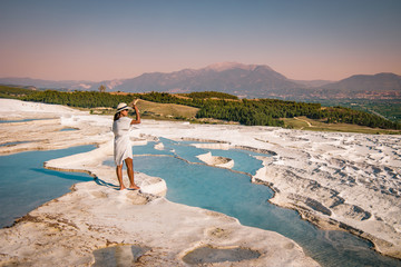 Wall Mural - The enchanting pools of Pamukkale in Turkey. Pamukkale contains hot springs and travertines, terraces of carbonate minerals left by the flowing water. The site is a UNESCO World Heritage Site.