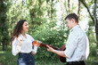 © soleg - young couple walking in the forest, playing guitar and dancing, summer nature, bright sunlight, shadows and green leaves, romantic feelings