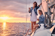 © Fxquadro - Female friends relaxing on the yacht with glasses of wine in the hands, during sunset on the high seas.