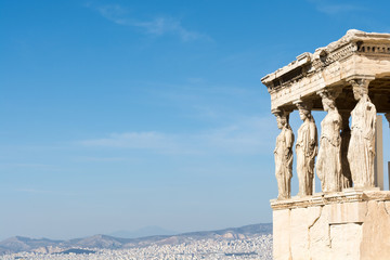 Wall Mural - Female statues called caryatids in the Erechtheion at the sacred rock of the acropolis of Athens