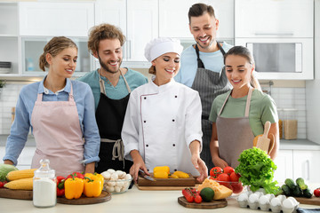 Wall Mural - Group of people and female chef at cooking classes