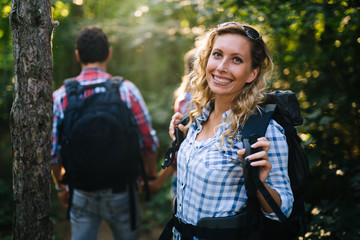 Wall Mural - couple trekking and hiking in forest