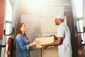 Delivery Service. Courier Delivering Package To Woman Near Car