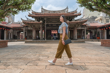 pretty asian woman taking a tour of the temple.