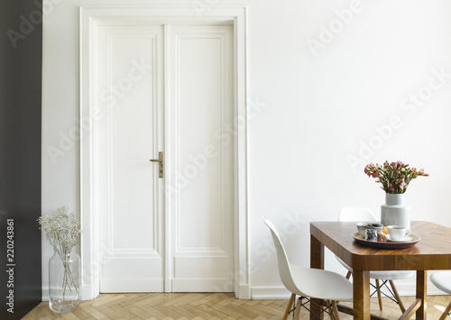 A White Wall With Double Door Next To Wooden Breakfast Table And - Dining Room Double Doors White A White Wall With Double Door Next To Wooden Breakfast Table And - Dining Room Double Doors White