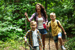 © BalanceFormCreative - Mother and her little sons hiking trough forest .They learning about nature.