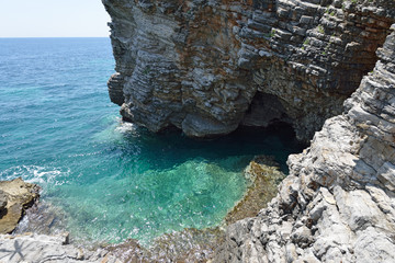 Panoramic view of the small cove and grotto in rocks.