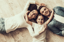 Happy Family Lying Of Floor Together At Home
