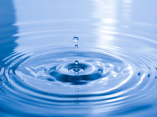  close up drop of water on blue background