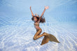 © Andriy Nekrasov - A girl in a mermaid costume poses underwater in a pool