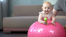 Cute Healthy Baby Enjoying Jumping On Big Ball, Fitness Exercises For Infants