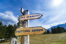 Signpost With Golf Course Information On The Wooden Sign Arrows.