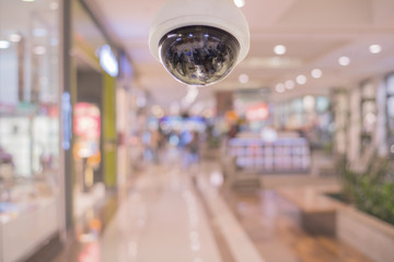 CCTV and blurred supermarket store blur background. Business protection.