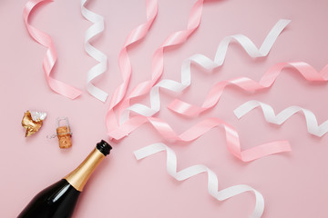 Wall Mural - Champagne bottle with ribbon. Flat lay, top view trendy holiday concept.