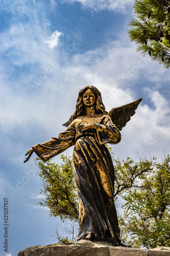 Fotografie, Obraz A bronze statue of an angel in Santa Maria di Leuca