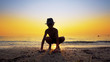 © zefart - Young boy with hat collecting peebles on beach and throw stone skipping game on sea sunset water surface, small flattened rock bouncing off water surface across body of water many times