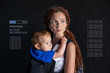 © Artem - Biometric verification. Modern young woman with a child. New technology of face recognition and protection
