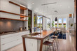 modern open plan white kitchen with wood detailing 