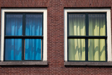 White Window With Blue And Yellow  Curtains On The  Retro  Red Brick Wall In Leiden