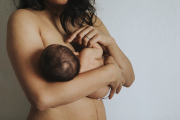Wall Mural - naked mother holding her newborn baby