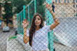 © Smile - Portrait of a swag girl behind rabitz fence