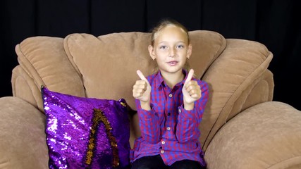 adorable happy girl talking, showing thumbs up and gesturing bye-bye