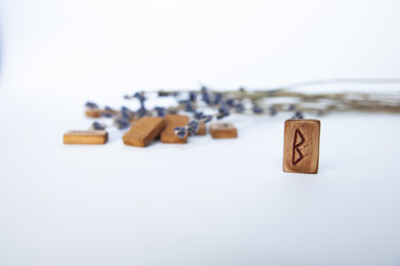 Wall Mural - Berkanan. Scandinavian runes. Wooden runes on a table on a white background.