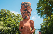 Cropped Shot View Of Traditional Maori Wood Carving Statue In Front Of Hastings Library.
