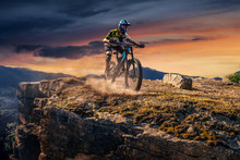 Mountain Biker On Sunset Stone Trail. Male Cyclist Rides The Rock