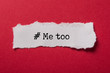 closeup of white torn paper on red paper background with text - # me too