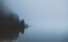 Mysterious Mountain Lake In Early Spring Morning. Spooky Dense Fog Covering The Water. Sleepy Misty Landscapes In Alps, Austria.