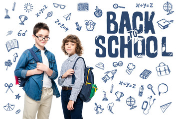 Wall Mural - two schoolboys with backpacks looking at camera isolated on white, with icons and 