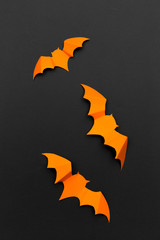 halloween and decoration concept - paper bats flying