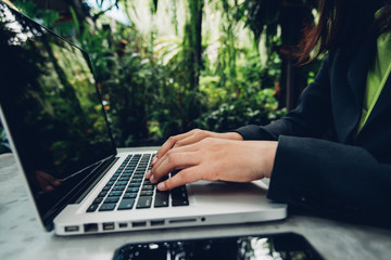 Business woman using his computer laptop on