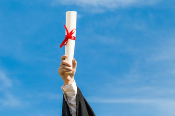 Close up hand of Graduate put hands up celebrating with certificate to the sky feeling so proud and happiness in Commencement day,Education Success Concept