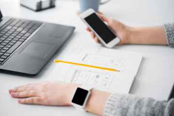 Wall Mural - app design, technology and business concept - web designer or developer with smartphone and sketch i