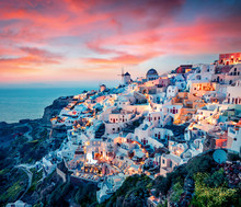 Impressive Evening View Of Santorini Island. Picturesque Spring Sunset On The Famous Greek Resort Oia, Greece, Europe. Traveling Concept Background. Artistic Style Post Processed Photo.