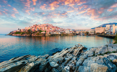 Wall Mural - sunny spring panorama of aegean sea. coloful sunrise in kavala city, the principal seaport of easter