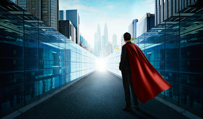 Wall Mural - Ambitions concept with hero businessman standing and looking from alley to modern city .