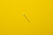 © FrauPixel - white ball pin on yellow background